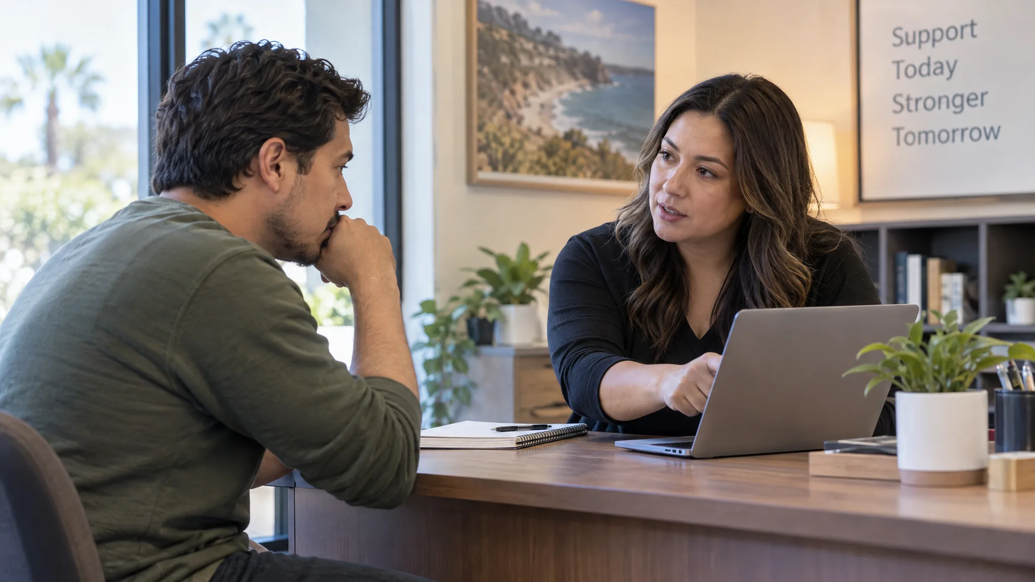 Adult discussing treatment coverage questions with an intake staff member